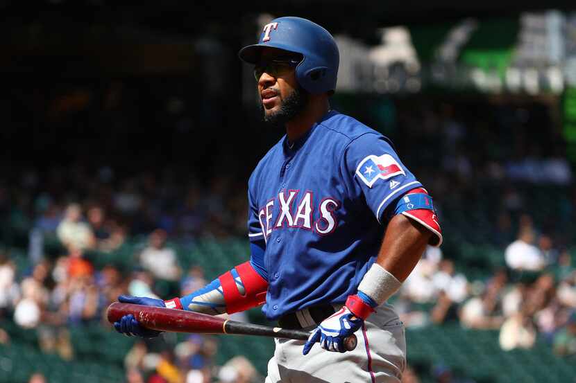 SEATTLE, WASHINGTON - JULY 24: Elvis Andrus #1 of the Texas Rangers reacts after striking...