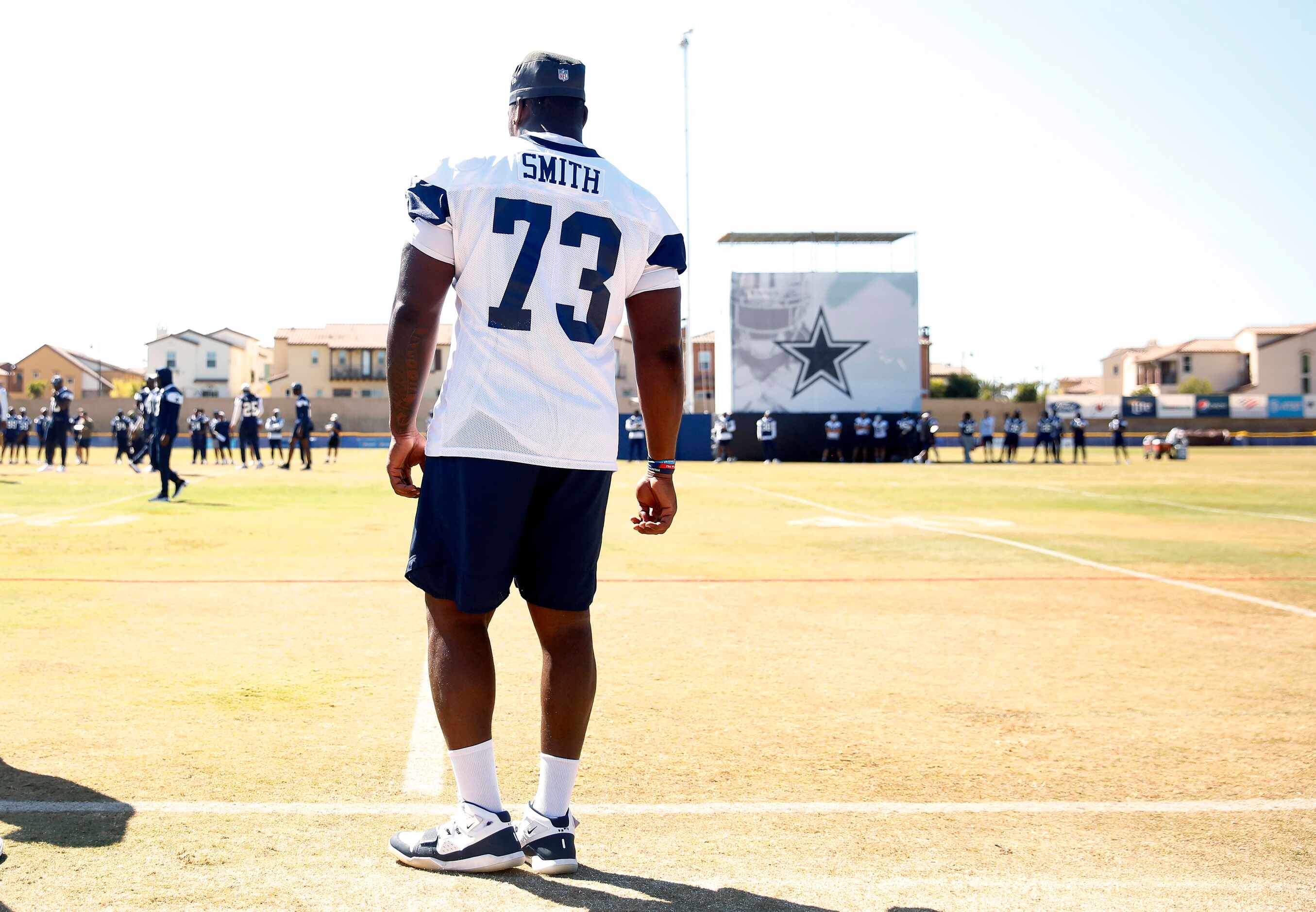 Dallas Cowboys rookie offensive tackle Tyler Smith (73) waits his turn to go in during a...
