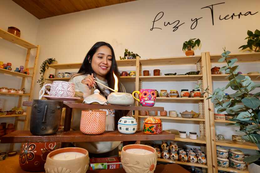 Grecia Alfaro lights a candle at her candle shop, “Luz Y Tierra,” which sells candles with...
