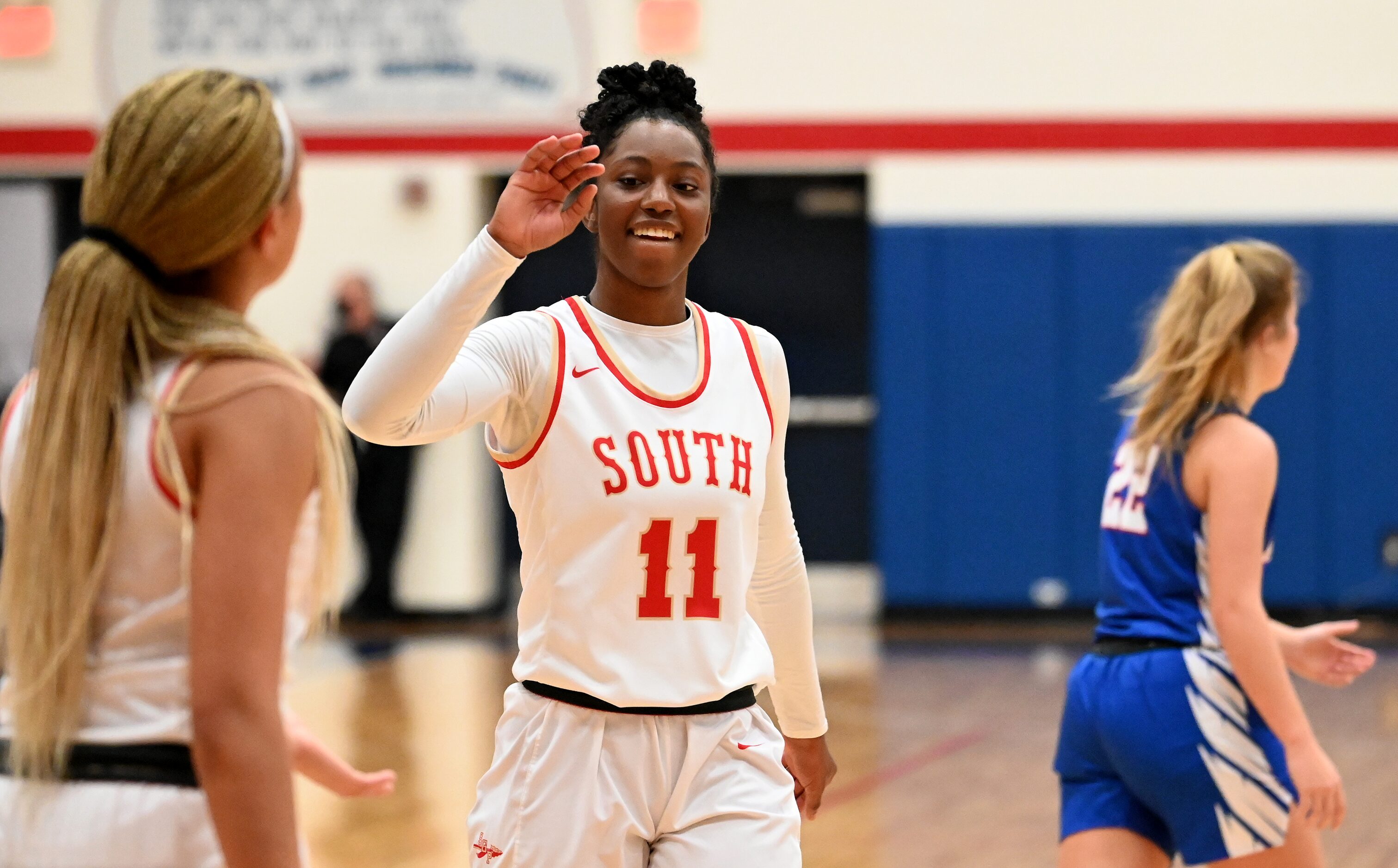 South Grand Prairie’s Jahcelyn Hartfield (11) and Kendall McGruder celebrate their 61-45 of...