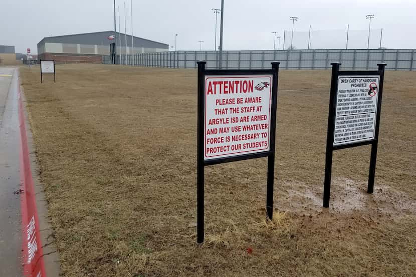 Signs alert those approaching Argyle High School in Argyle, Texas, that staff are armed.