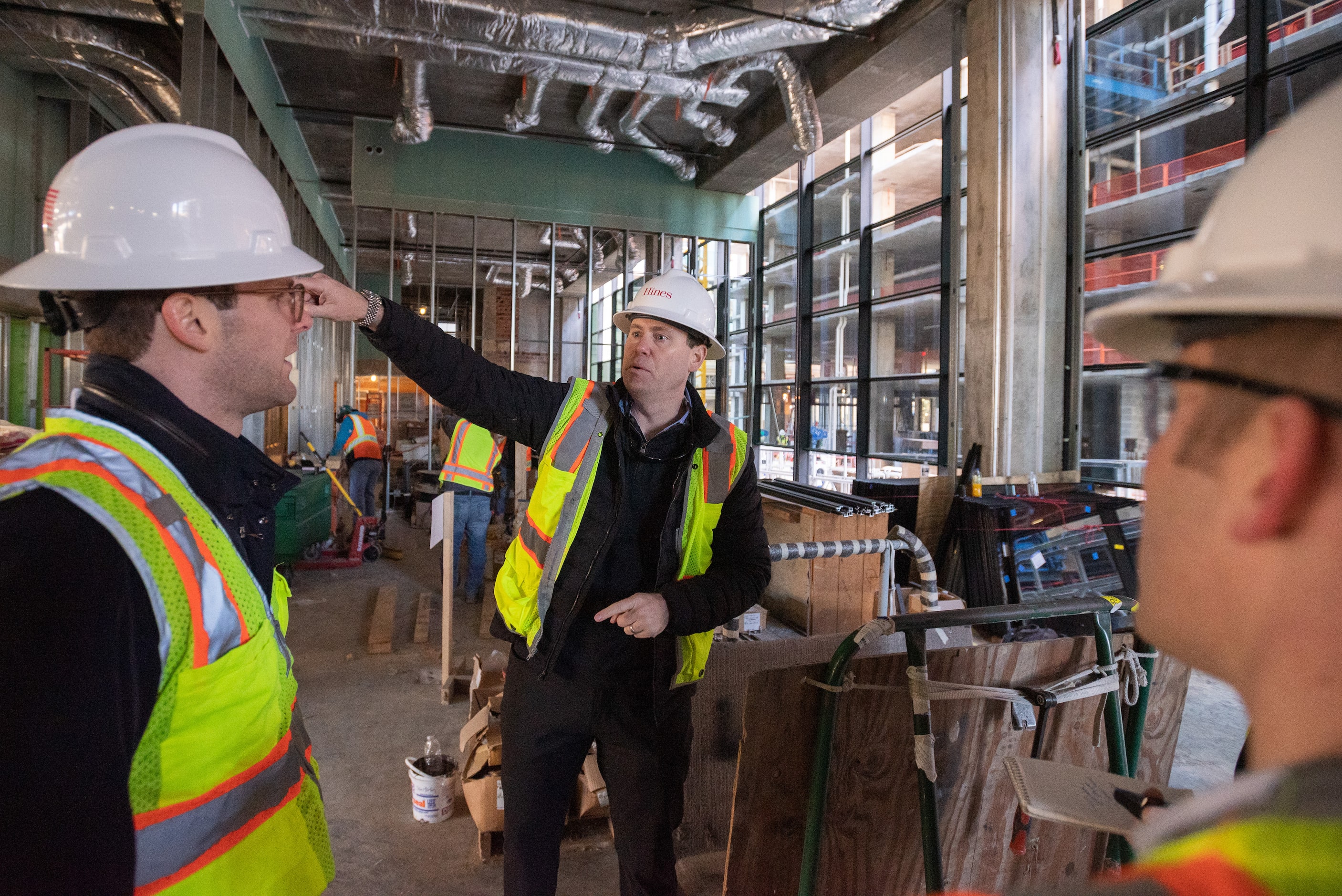 Sean Luther, Hines associate, left, Ben Brewer, Hines Senior Managing Director, and David...