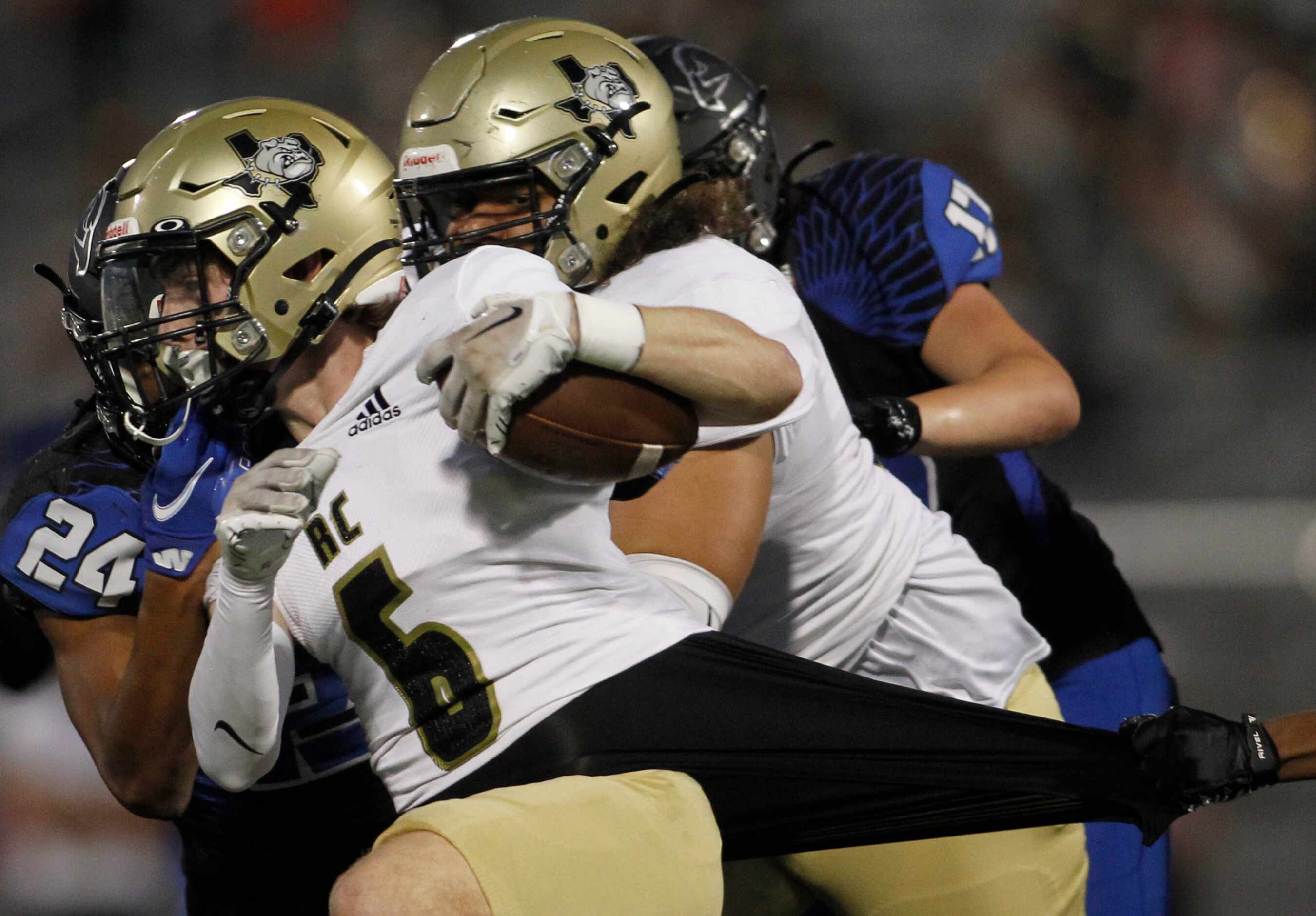 Royse City running back Aidan Walker (6) rushes against the defense of North Forney defender...
