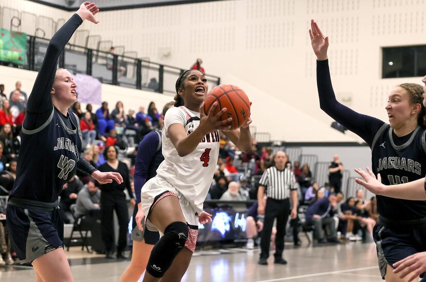 Denton Braswell guard Kennedy Evans (4) goes hard to the basket past Flower Mound forward...