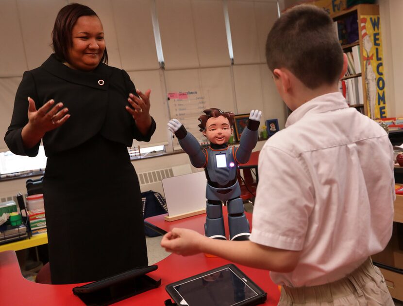 Teacher Karol Henderson (left) and 7-year-old Maxwell Cowles dance with Milo. (Jason...