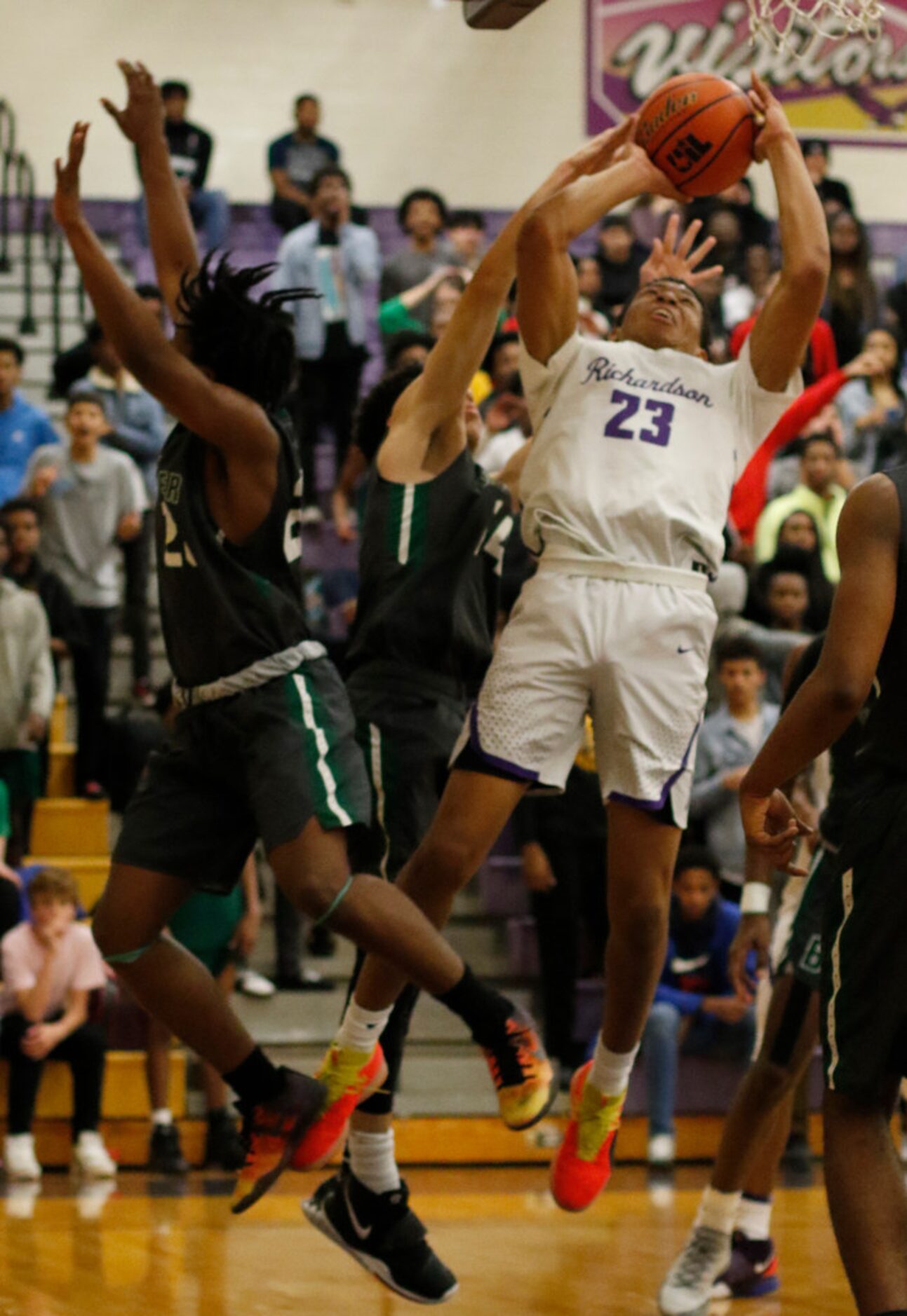 Richardson's Derek Burns (23) puts up a shot in heavy traffic during first half action...