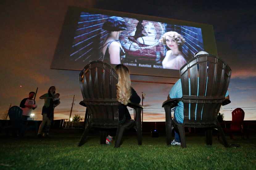 Tina and Art Lira of Lewisville settled in to watch the "Coming Attractions" reel at the...