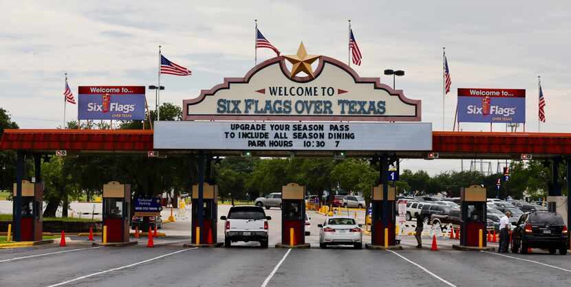 U.S flags flew on the "Welcome to Six Flags Over Texas" sign on Aug. 18, 2017.