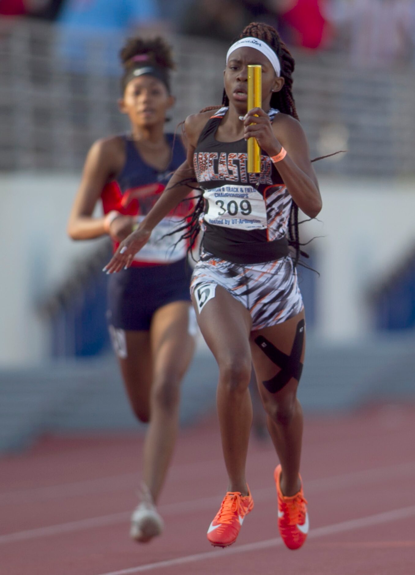 Lancaster's Addison Stricklin carries the baton to a first place finish as anchor of the...