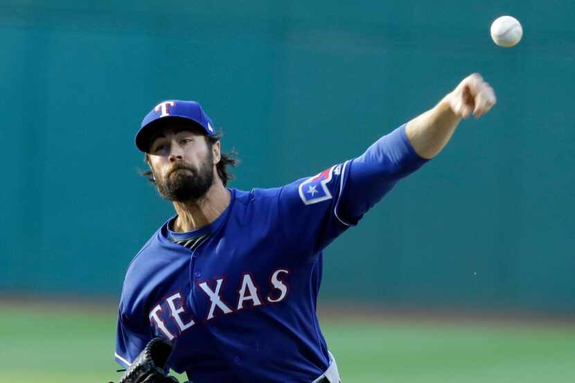 Texas Rangers starting pitcher Cole Hamels delivers in the first inning of a baseball game...