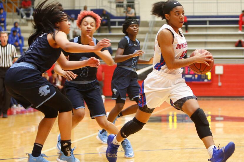 Duncanville guard Angel Kelly (12) drives to the basket past the defense of 3 Lovejoy...