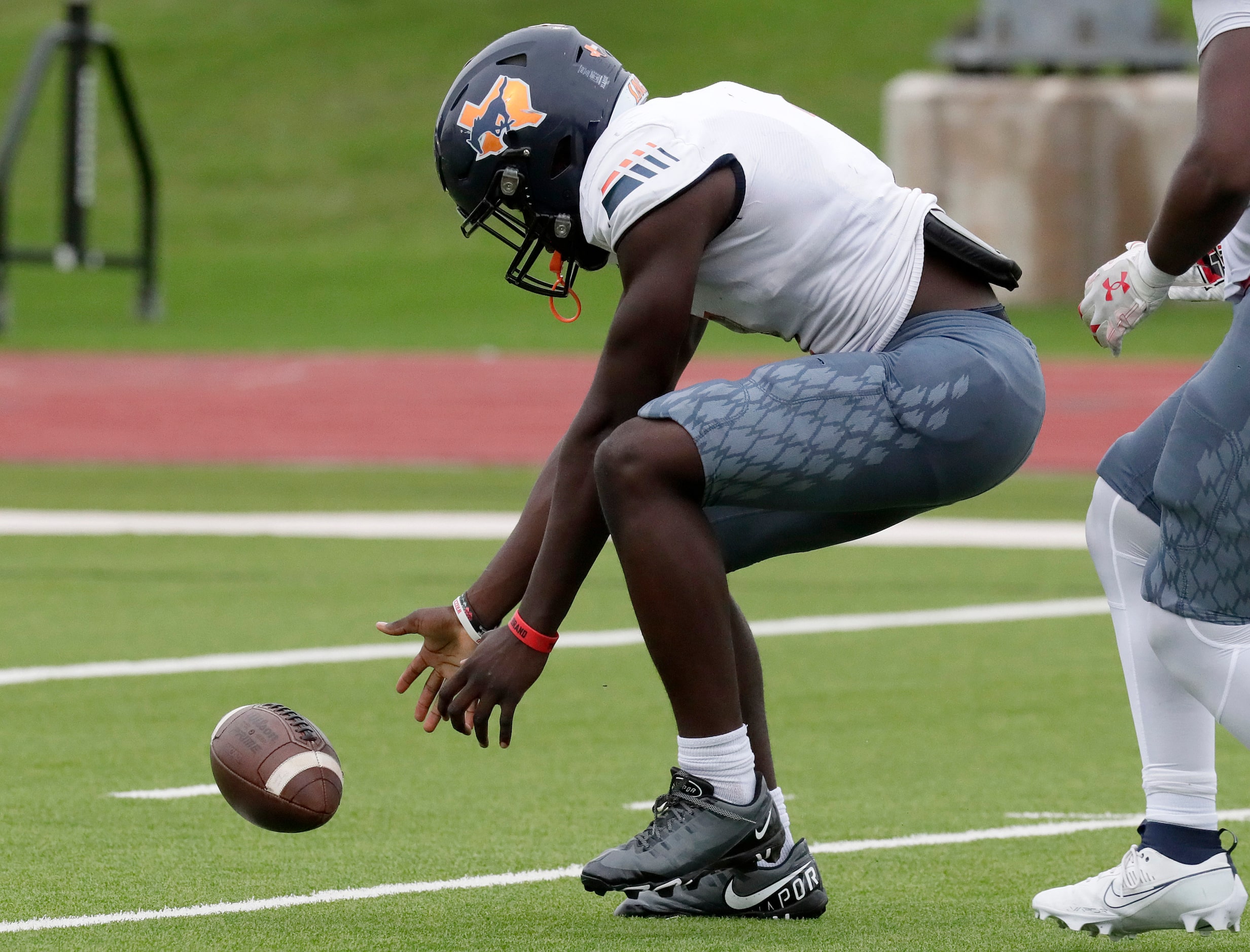 Sachse High School defensive end Cheta Ofili (1) picks up a fumble and goes a short distance...