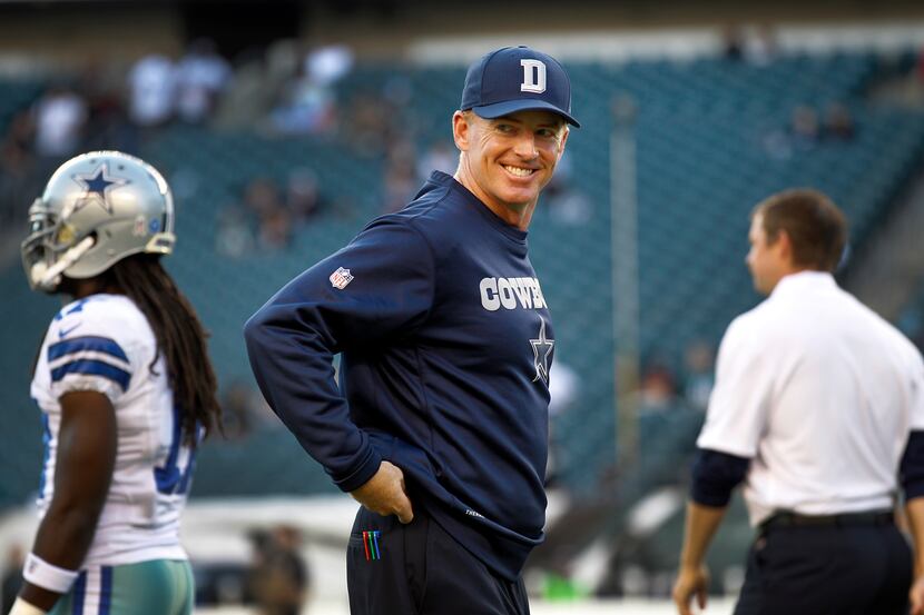 Cowboys head coach Jason Garrett smiles at his players as they take the field for warm-ups...