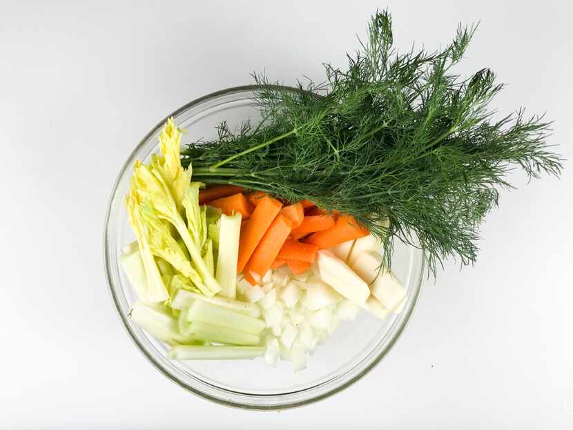 Aromatic vegetables — carrots, onions, celery, parsnip — and dill are key ingredients in...