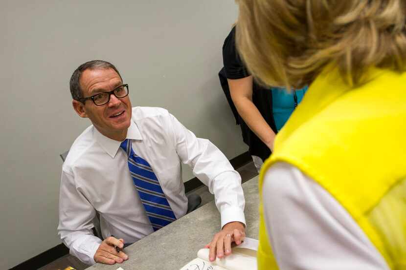 Best-selling author Daniel Silva signs copies of his new novel, The Black Widow, before his...