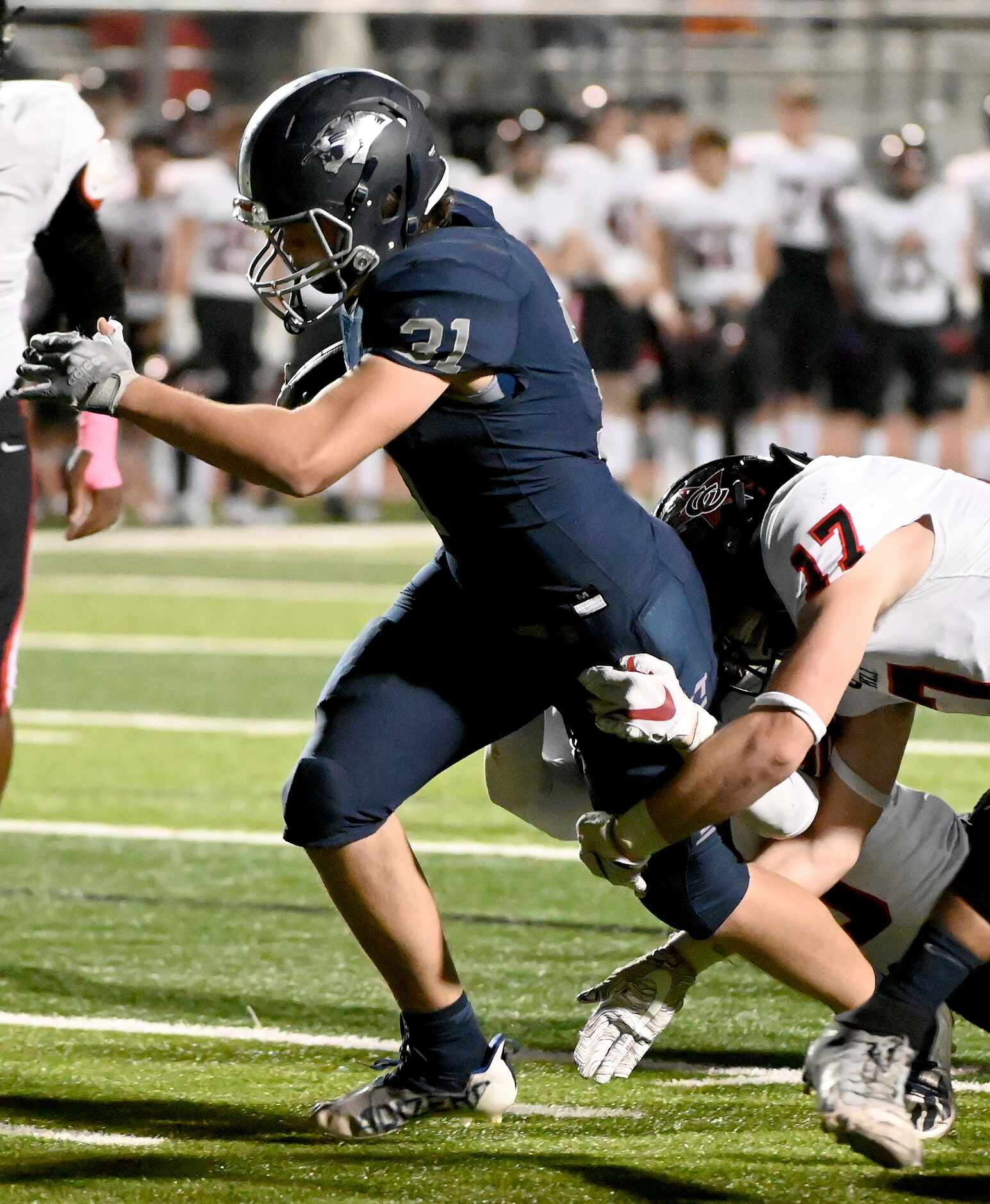Flower Mound's Peyton Porter (31) runs through tackle attempts by Coppell’s Jack McAdams...