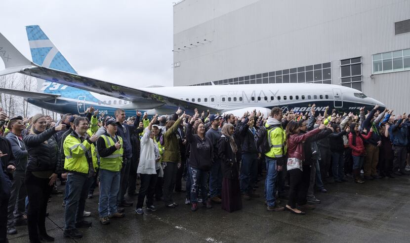 Employees gathered for a photo after the first Boeing 737 MAX 7 aircraft was unveiled on the...
