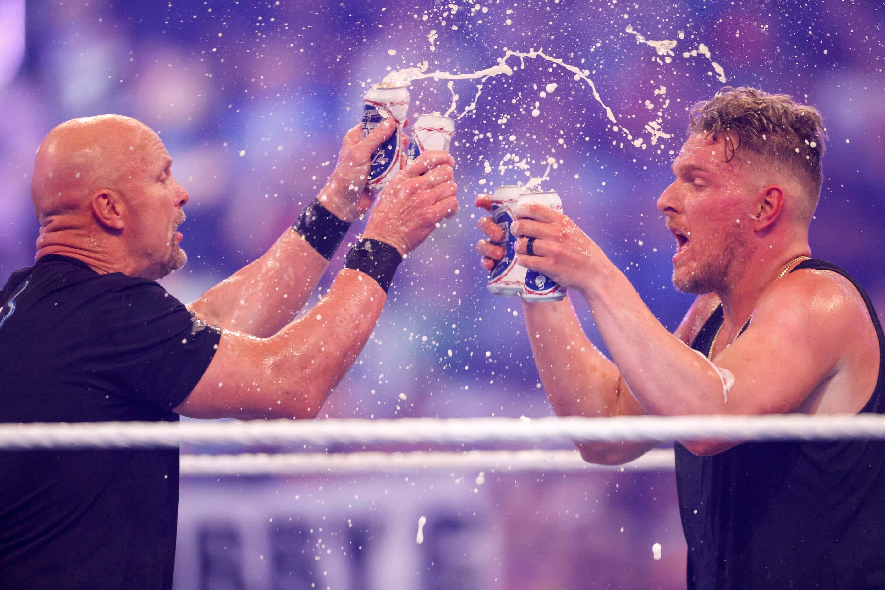 “Stone Cold” Steve Austin toasts beer with Pat McAfee after a match at WrestleMania Sunday...