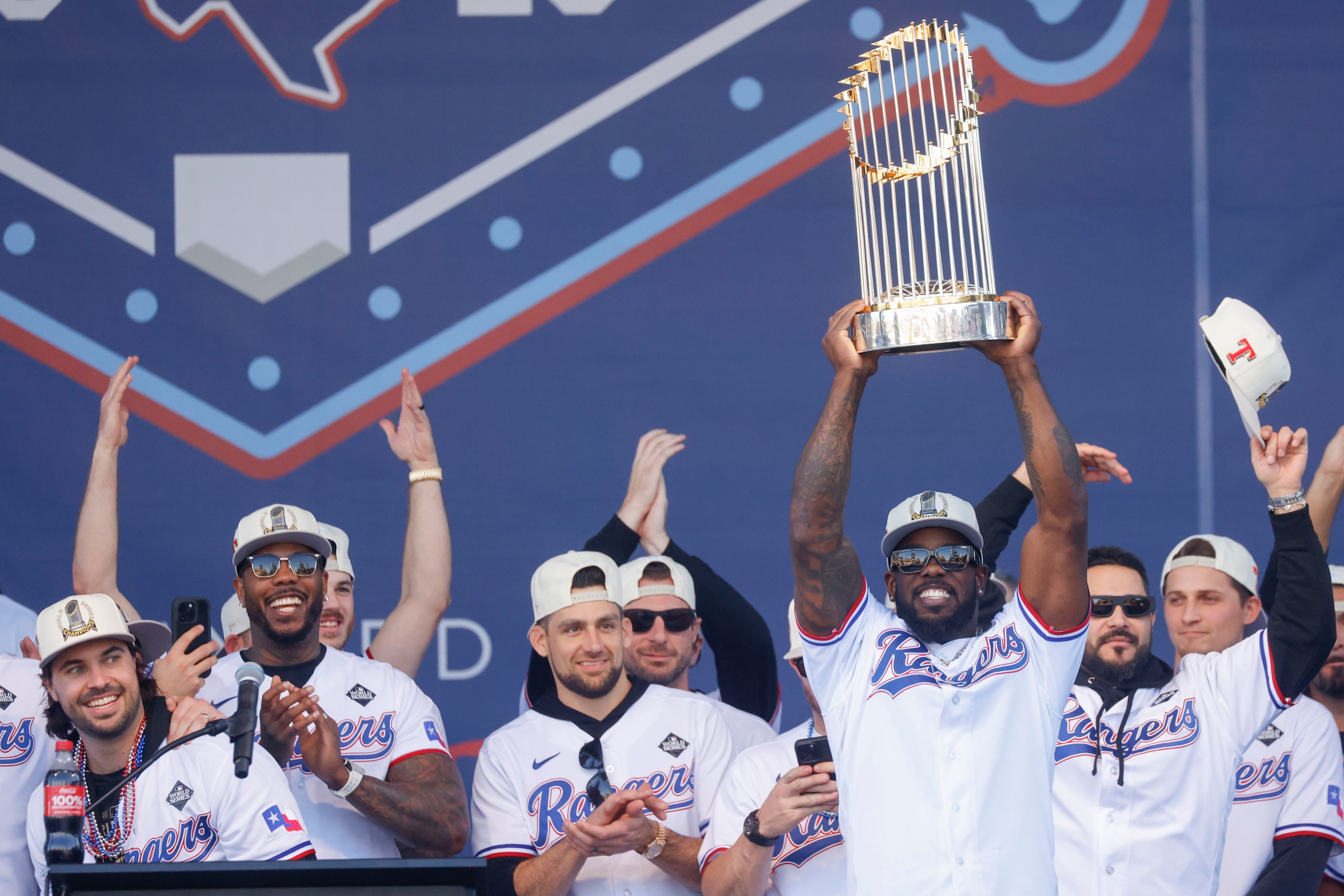 Texas Rangers’ Adolis García hoists the Commissioner's Trophy during Texas Rangers World...