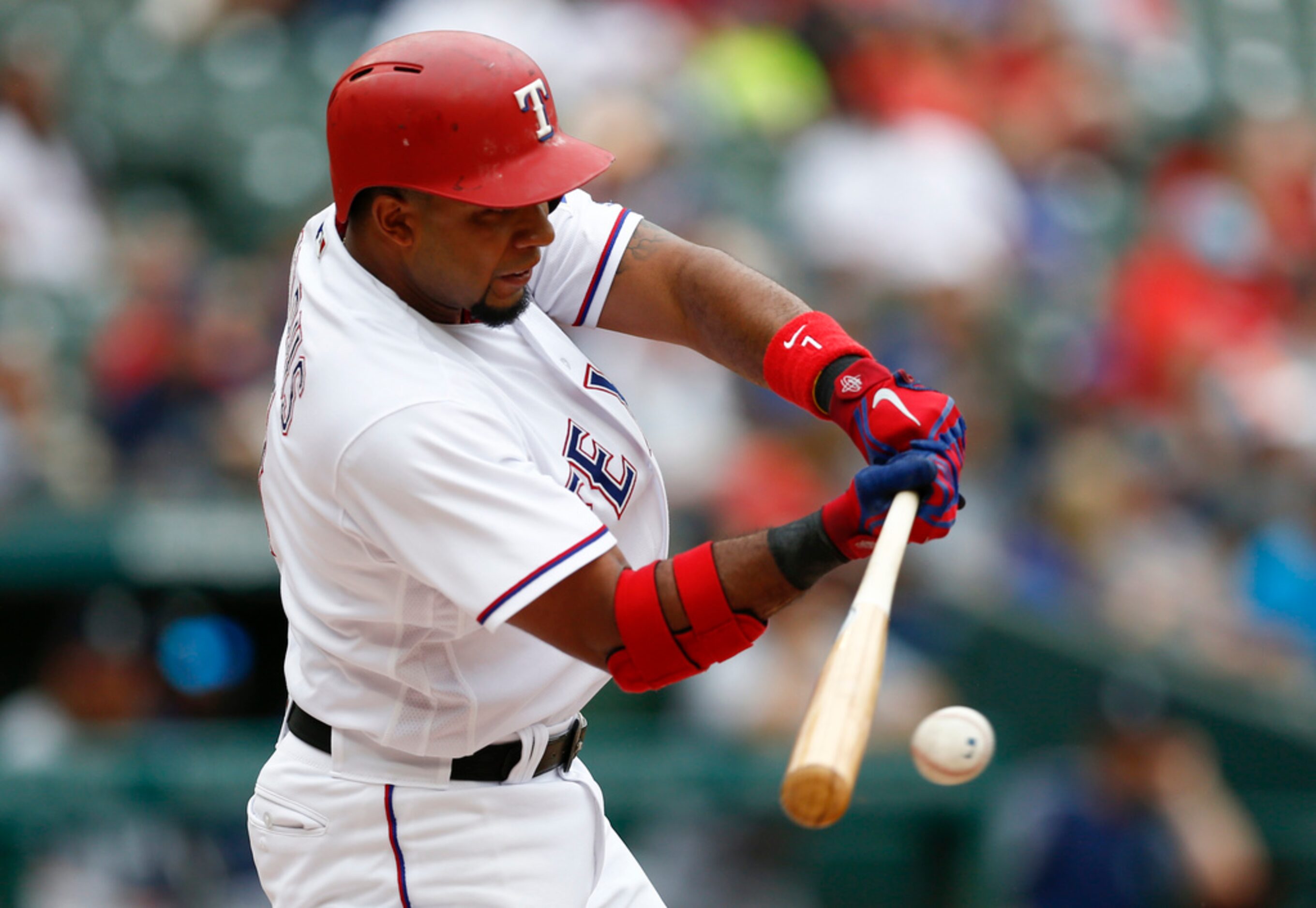 Texas Rangers' Elvis Andrus singles against the Seattle Mariners during the first inning of...