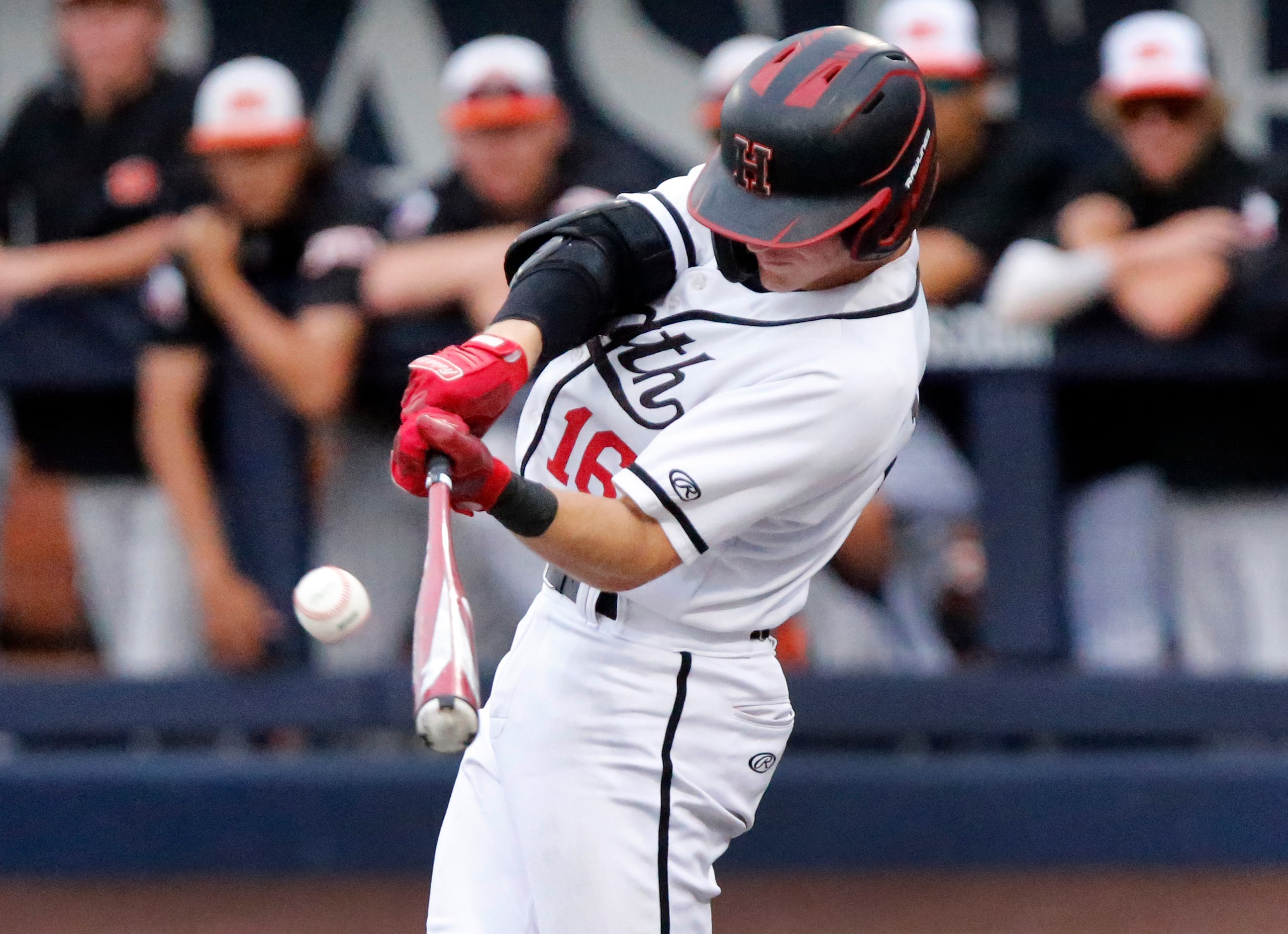 Heath second baseman aden Fiveash (16) makes contact in the first inning as Rockwall Heath...