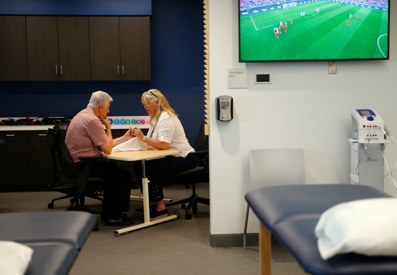 Hal Daughtery of Plano works with Alison Taylor, a certified hand therapist, during a...