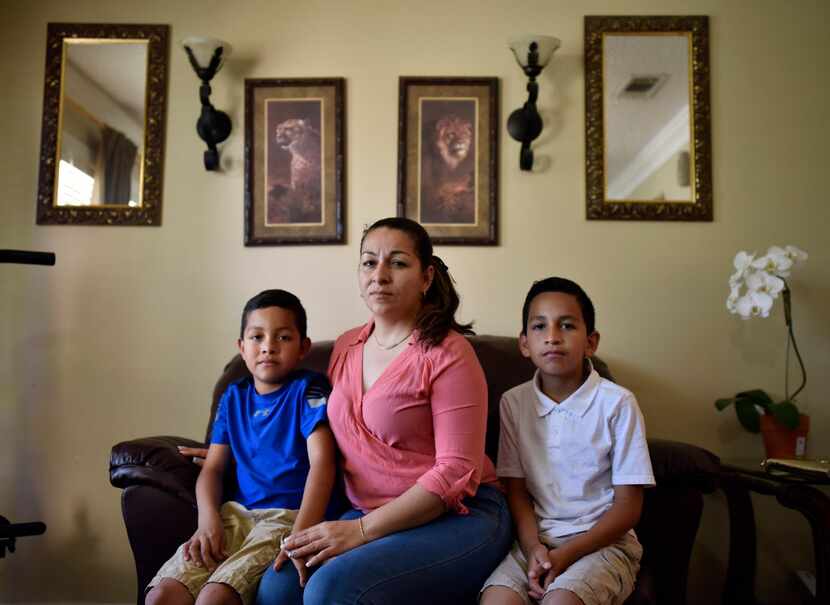 Marta Hernandez, who came to the U.S. from El Salvador with her children Cesar Reyes, 11,...