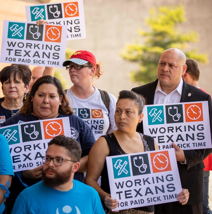 City Council member Adam Medrano (right) held a sign during a June 2018 news conference...