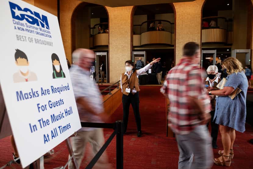 Signage at left informs patrons of the mask requirements inside the Music Hall at Fair Park...