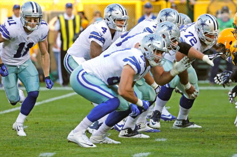 Dallas Cowboys quarterback Dak Prescott (4) takes the snap as receiver Cole Beasley (11)...