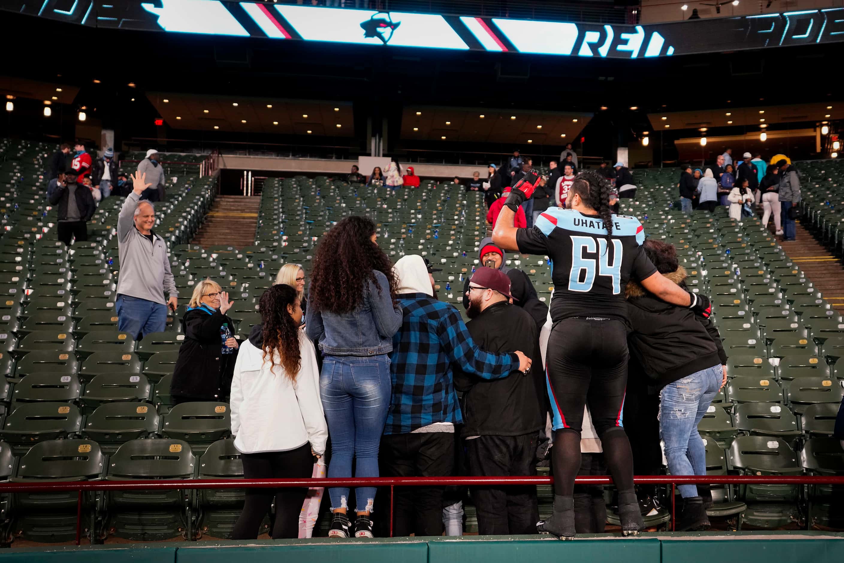 Dallas Renegades offensive guard Salesi Uhatafe (64) poses for photos with his family after...