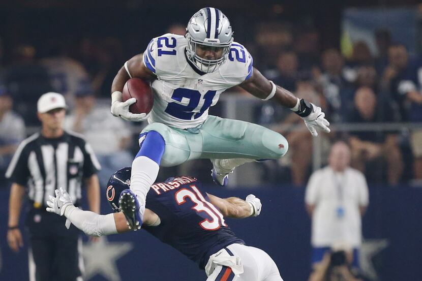 Dallas Cowboys running back Ezekiel Elliott (21) leaps over Chicago Bears strong safety...