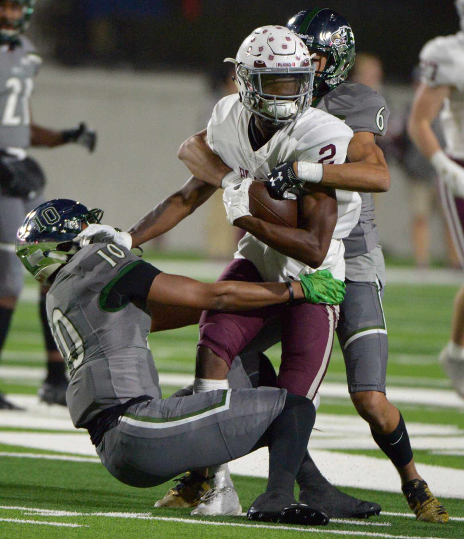 Prosper's Joshua Graham (10) and Deven Leith-Mathis (6) tackles Plano's Nolan Williams in...