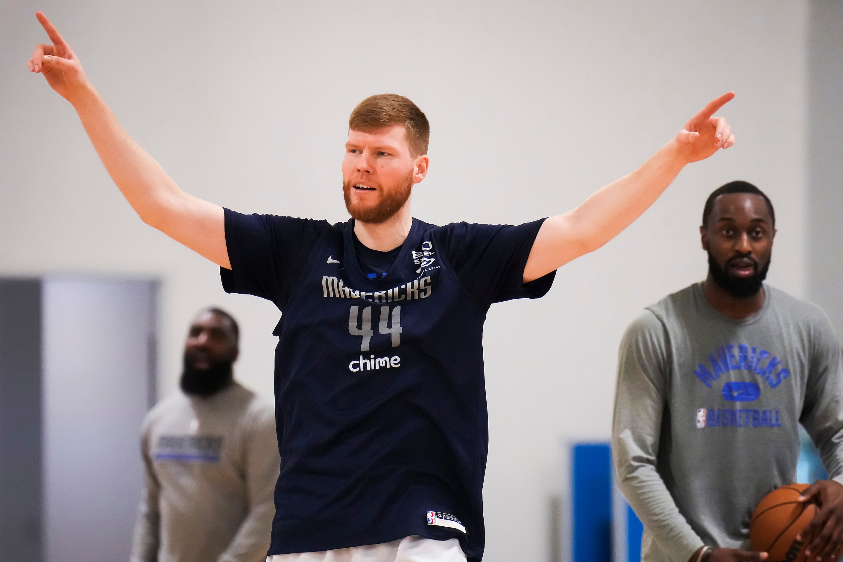 Dallas Mavericks forward Davis Bertans motions to teammates as the team practices in...