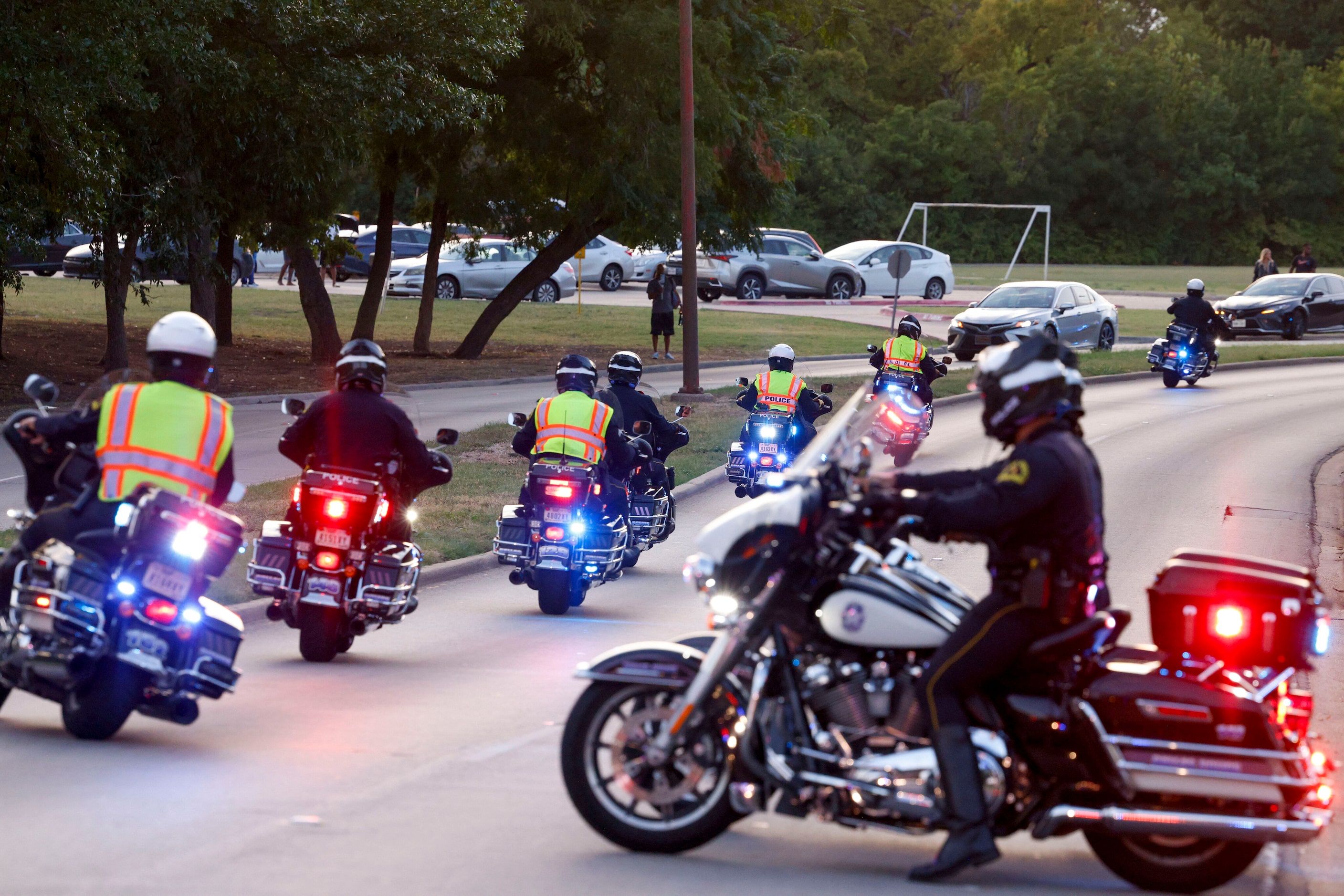 Members of the Dallas police motorcycle unit leave to escort the family of Officer Darron...