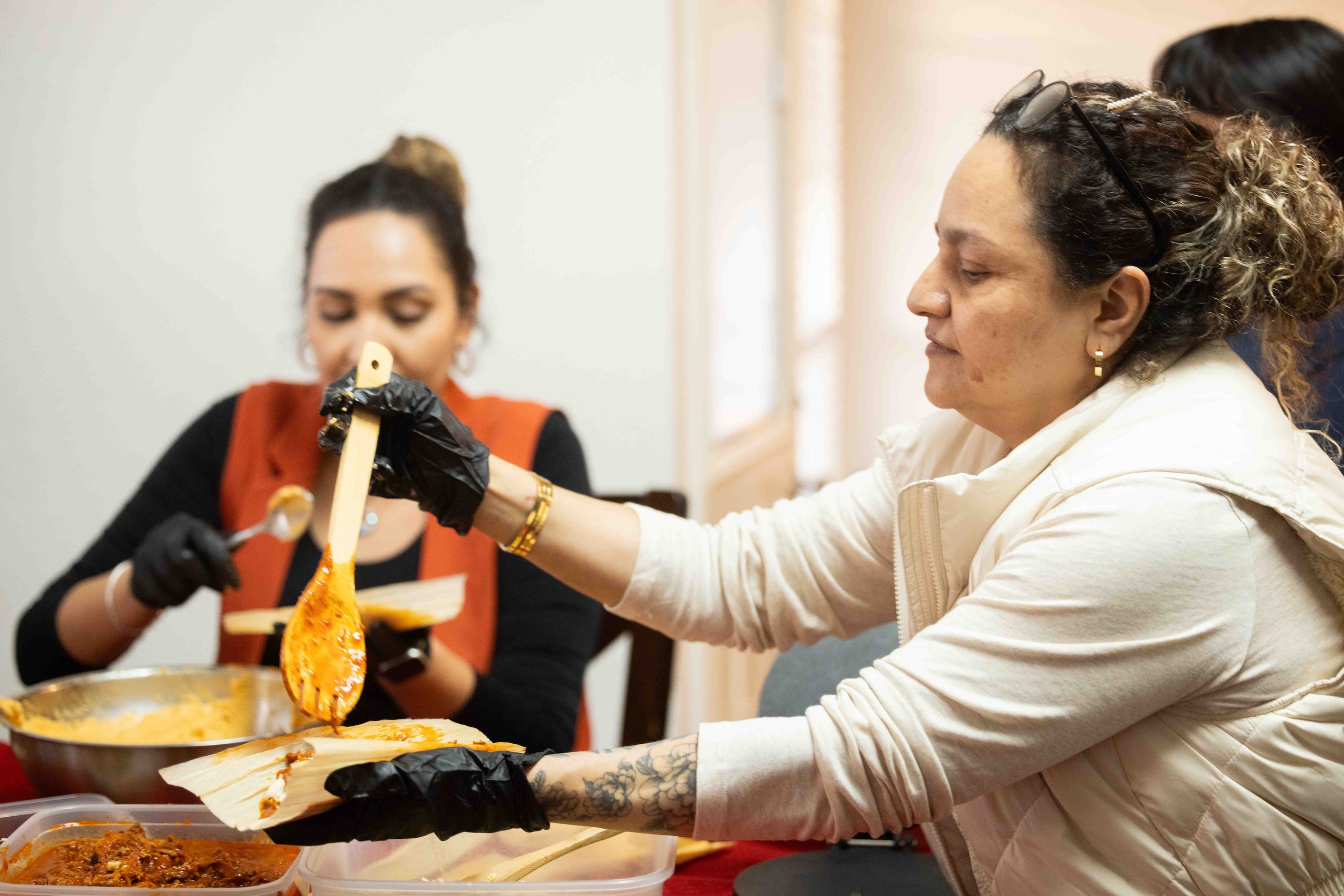 Cecilia Martínez of Michoacán helps Sara Klein (not pictured), the hostess behind the...