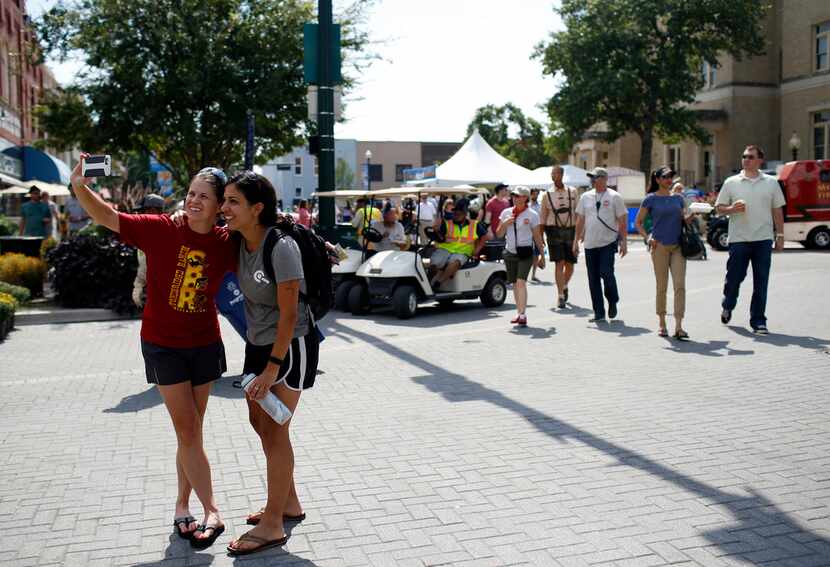 Rachel Felts (left) and Sarah Thomas take a selfie at the McKinney Oktoberfest in historic...