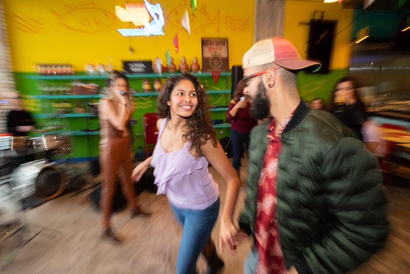 Cristina Vega, 28, left, dances cumbia with Giancarlo Rinaldini, 24, during a performance by...