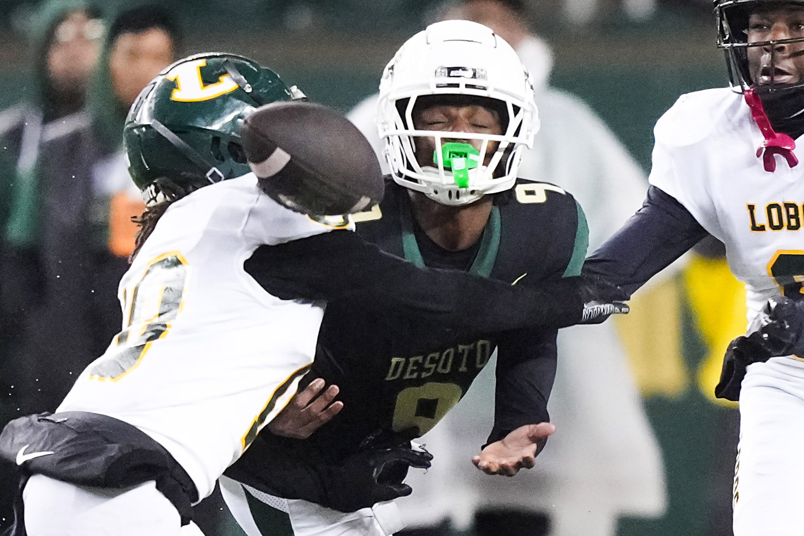 Longview’s Bradley Williams (18) breaks up a pass intended for DeSoto wide receiver Kristoff...