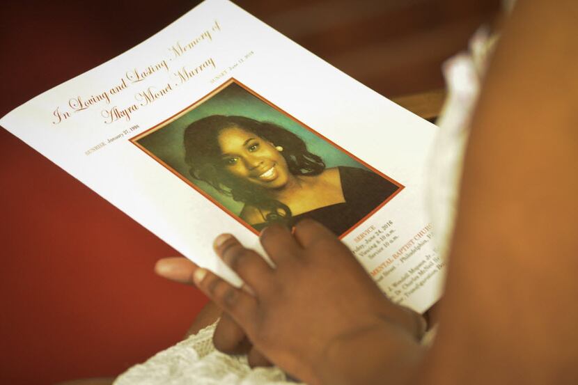 Unidentified woman holds a program for the funeral service for Akyra Murray at Monument...
