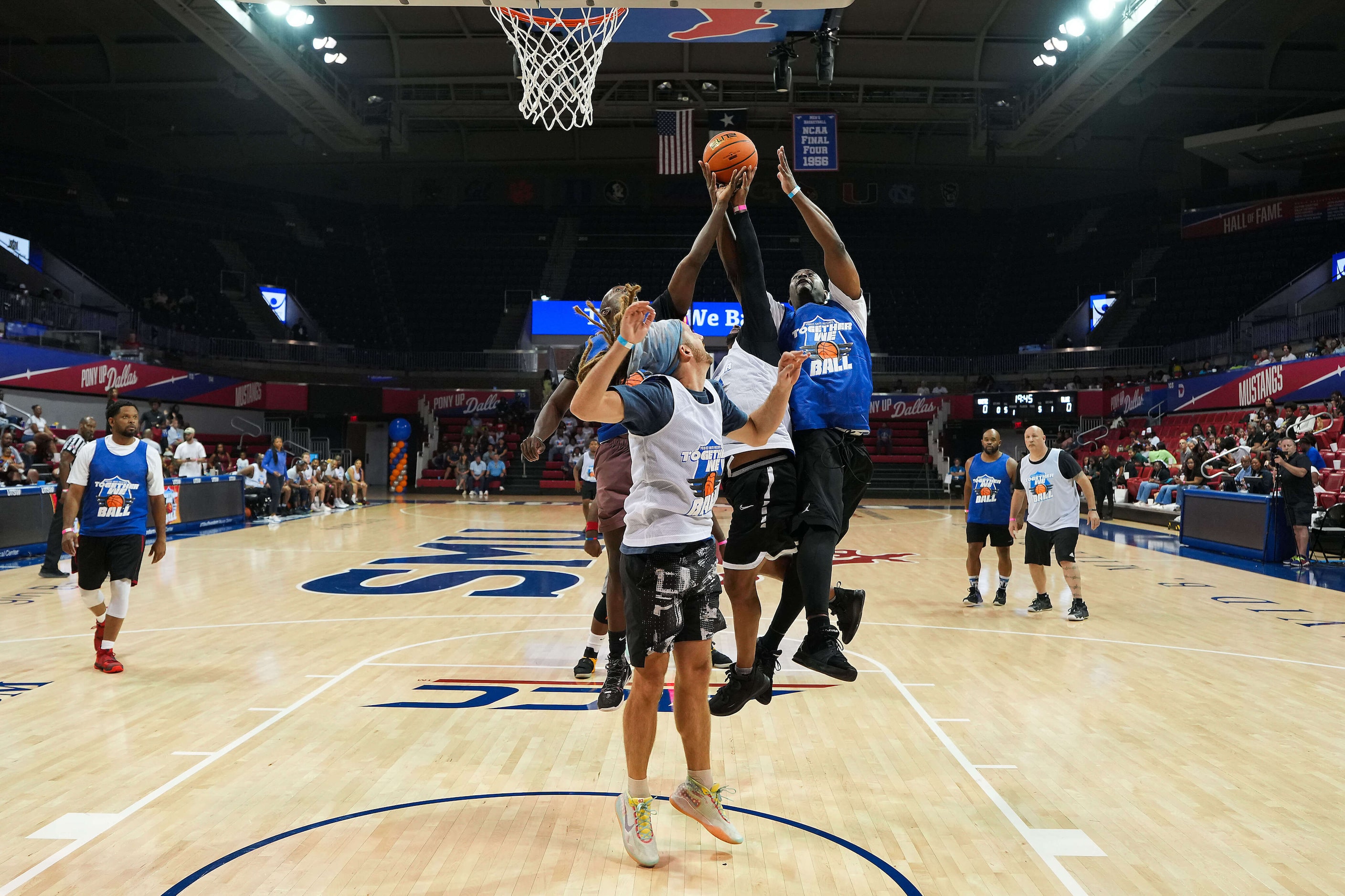 Mark Grafenreed, pastor at St. Luke Community UMC (right in blue) leaps for a rebound with...