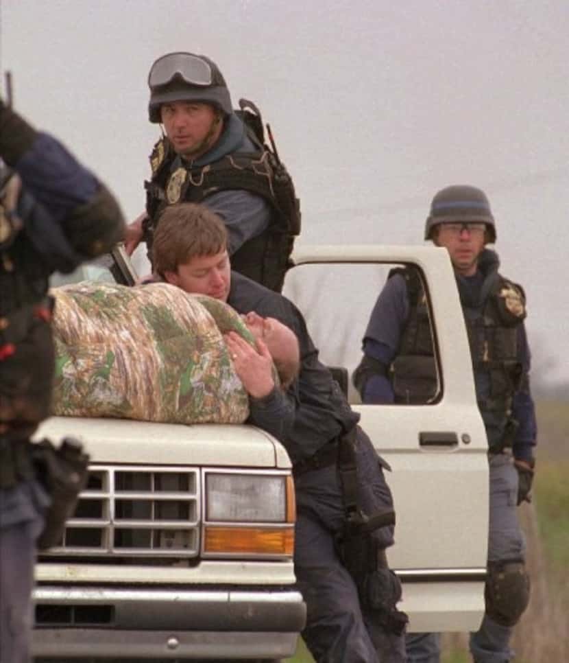 ATF agents help Bill Buford away from the Branch Davidian compound on Feb. 28, 1993, after...