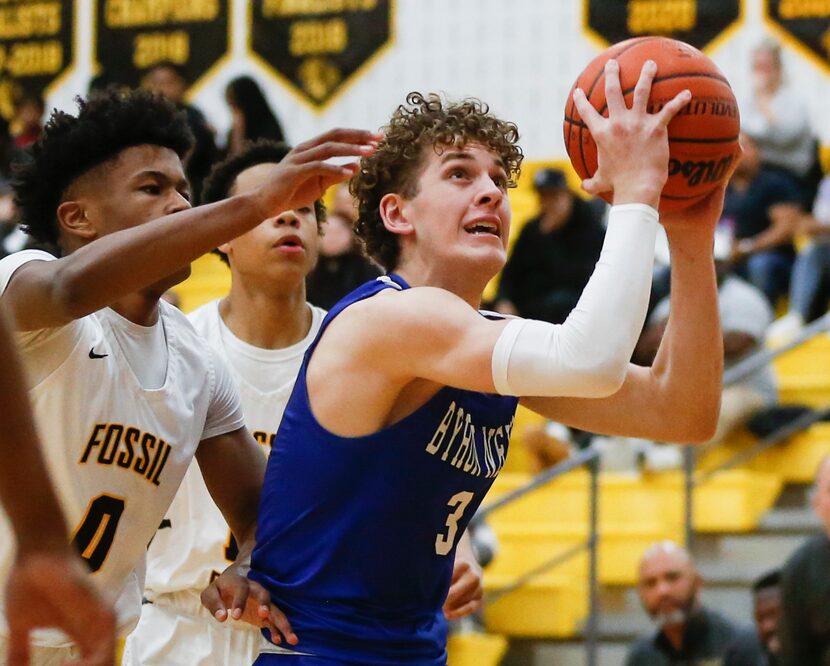 Byron Nelson High School Finley Bizjack (3) holds the ball ready to shoot during the first...