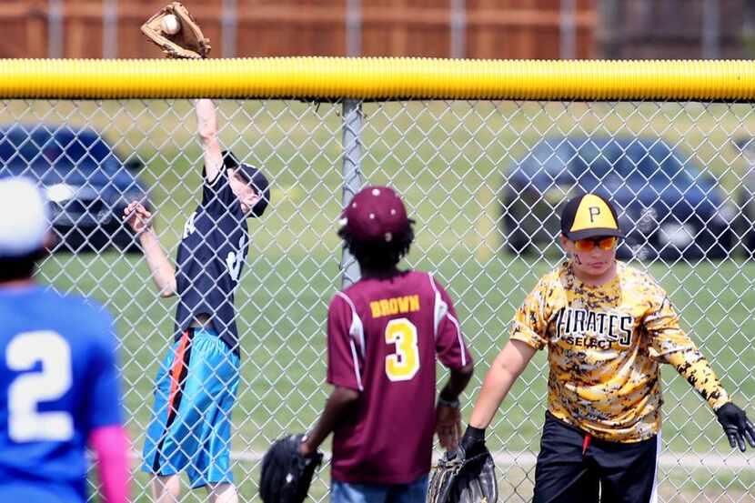 
Youth league players field balls during the home run derby for 11-year-olds at Mesquite's...