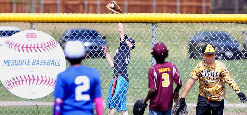 
Youth league players field balls during the home run derby for 11-year-olds at Mesquite's...