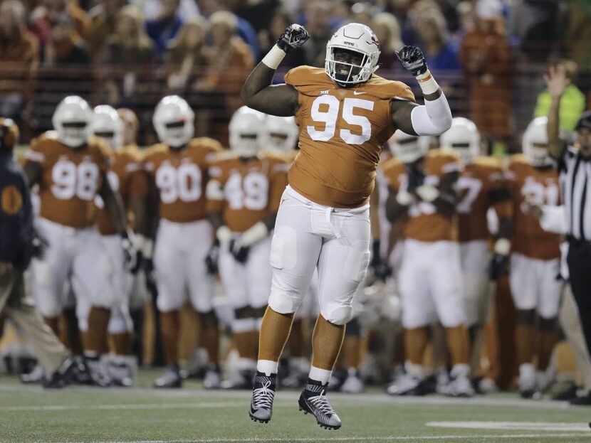 FILE - Texas defensive tackle Poona Ford (95) celebrates after he sacked Kansas quarterback...