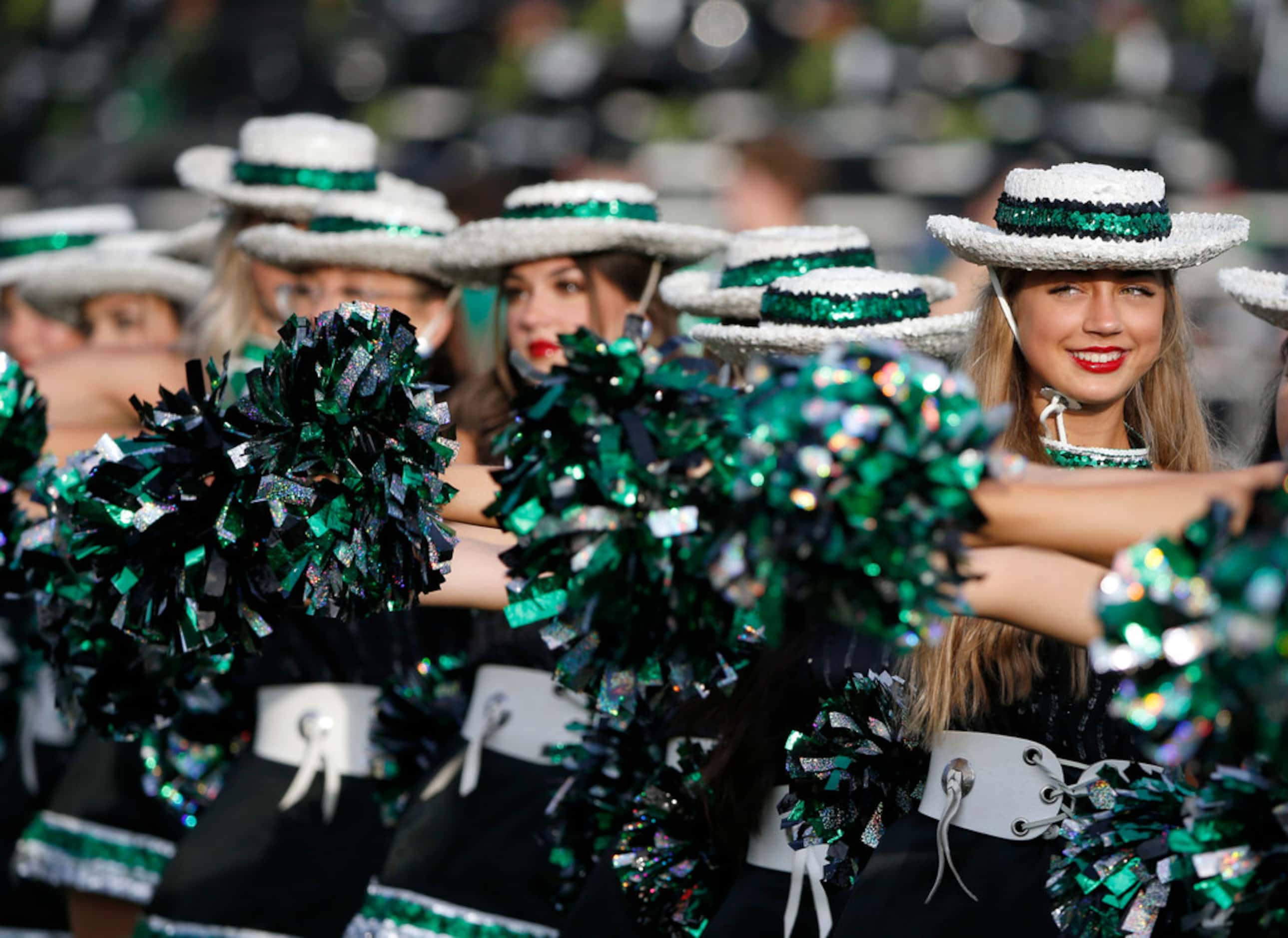 Southlake Emerald Belles drill team members  line up prior to their high school football...
