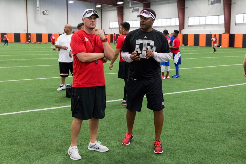 University of Houston football head coach Tom Herman (left) chats with Texas A&M football...