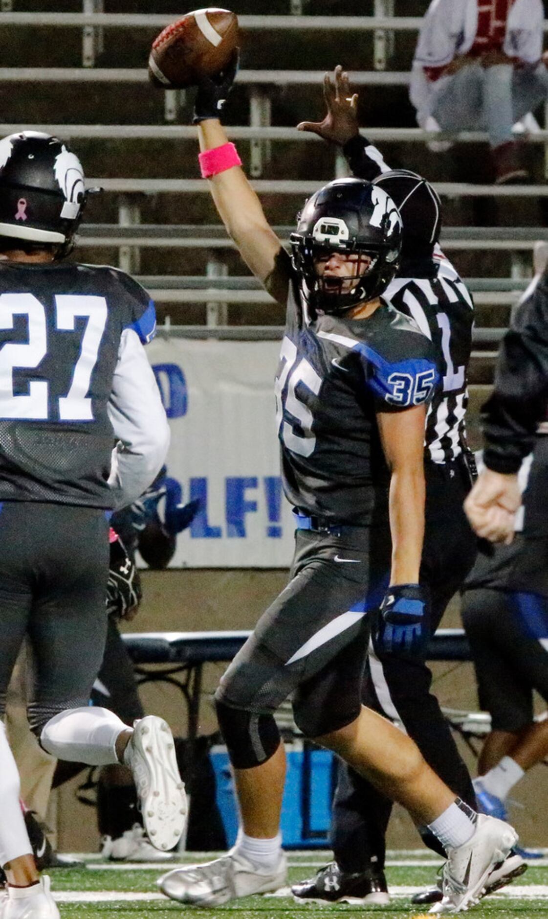 Plano West High School defensive back Cade Hathaway (35) hoists up the ball after he...