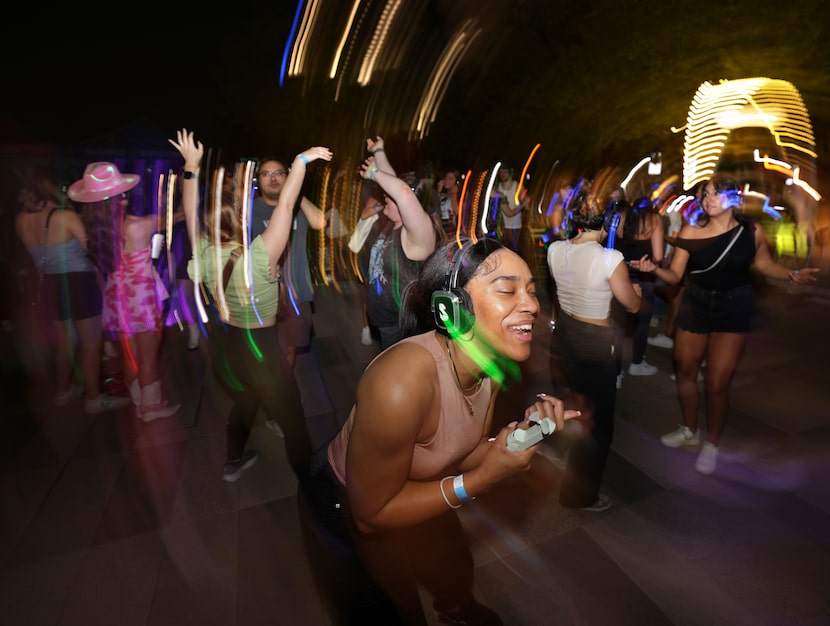 Guests participate in a silent disco at Klyde Warren Park in Dallas on Sept. 6, 2024.